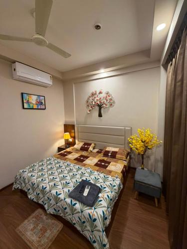 a bedroom with a bed and flowers in it at Max Stays in Greater Noida