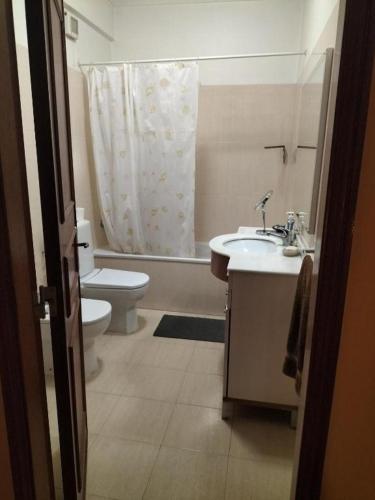 a bathroom with a sink and a toilet and a shower at Oeiras Central, near Beach & Public Transport in Oeiras