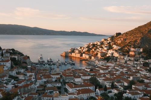 a view of a town with boats in the water at Rallou House Hydra in Hydra