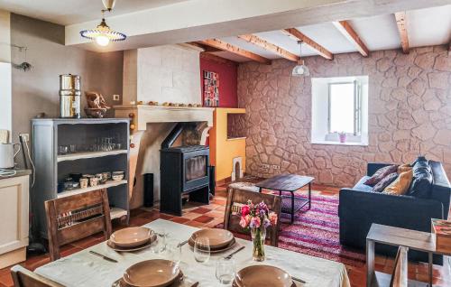 a living room with a table and a fireplace at Harmant Gîte Au Calme in Saint-Maigrin