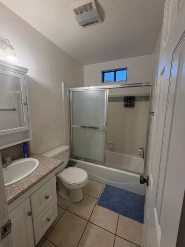 a bathroom with a toilet and a sink and a shower at Palm Cabin in San Gabriel