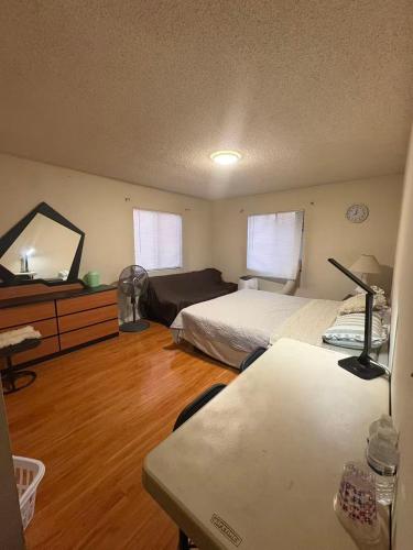 a bedroom with two beds and a desk with a mirror at Palm Cabin in San Gabriel