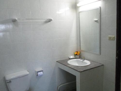 uma casa de banho com um lavatório, um WC e um espelho. em Muang Thong Family Suite Hatyai em Hat Yai