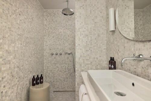 a bathroom with a sink and a toilet and a mirror at COMO Cordeillan-Bages in Pauillac