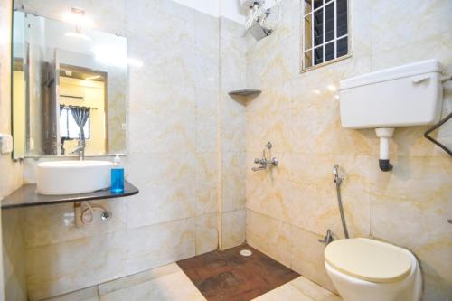a bathroom with a toilet and a sink at II JAGUAR VILLA lI in Lonavala