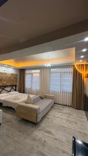 a large bedroom with two beds and a couch at PERLA SUİTES hotel in Istanbul