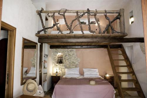 a bedroom with a bunk bed with a ladder and a mirror at Villa Salinara in Marsala