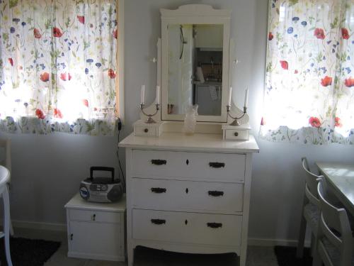 a dresser with a mirror on top of it at Fårö stonehouse in Fårö