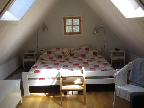 a bedroom with a bed with a dog laying on it at Fårö stonehouse in Fårö