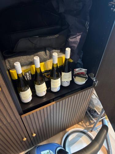 a group of bottles of wine in a car trunk at 2BR Sunset View House in Coron Town Proper in Coron