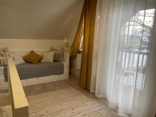 a bedroom with a bed and a window at Tamme maja - Oak Tree House with big terrace and balcony in Tapa