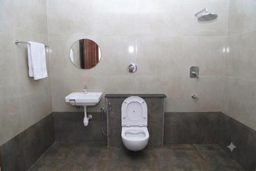 a bathroom with a toilet and a sink at L2 Retreat in Kottakupam