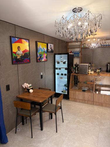 a dining room with a table and chairs and a chandelier at Hostel 1869 in Karakol