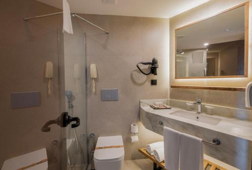 a bathroom with a sink and a shower and a toilet at SİDE SUN in Manavgat