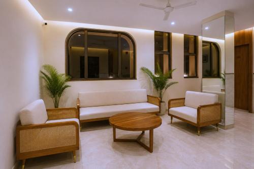 a living room with a couch and two chairs and a table at Raahi Home Stay Near Iskcon temple & Pushpa Mission Hospital in Ujjain