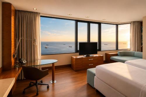 a hotel room with a bed and a desk with a television at Sheraton Istanbul Atakoy Hotel in Istanbul