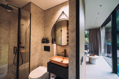 a bathroom with a sink and a toilet and a shower at Stars Resort Sigulda in Sigulda
