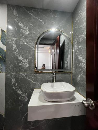 a bathroom with a sink and a mirror at HoTeL Long Phụng 1 Quận Bình Tân in Ho Chi Minh City