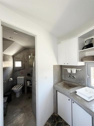 a bathroom with a toilet and a sink at Anemos Mill House in Imerovigli