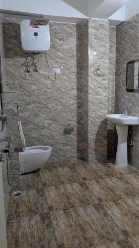 a bathroom with a toilet and a sink at Twin Garden by TAPSOM in Tādong
