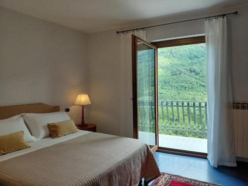 a bedroom with a bed and a large window at B&B Piazza Marconi in Castelpizzuto