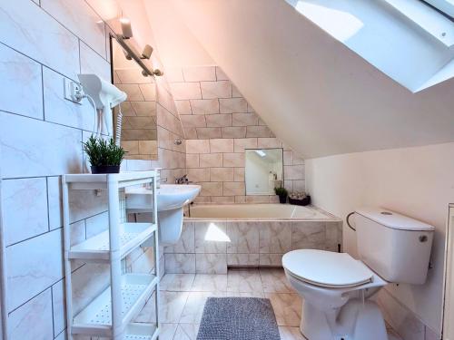 a bathroom with a toilet and a sink and a tub at Noclegi Słodki Sen 2 in Lublin