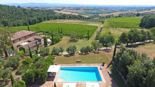 an aerial view of a villa with a swimming pool at Abbadia Wine Relais in Montefollonico
