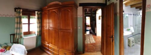 a bathroom with a wooden cabinet and a sink at Antigua Posada, Valle del Jerte in Tornavacas