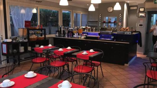 a restaurant with red tables and chairs and a counter at Hotel Center 1&2 in Rome