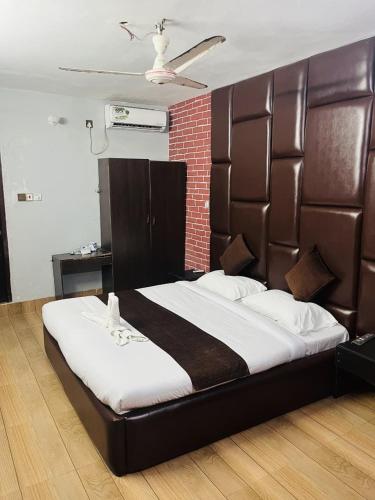a large bed with a large headboard in a room at Ostad Jahangir Resort in Cox's Bazar