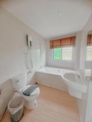 a bathroom with a toilet and a sink and a bath tub at PAI LAMUN VALLEY in Pai