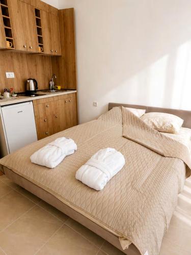 a bedroom with a bed with two towels on it at Apartments Skadar Lake in Vranjina