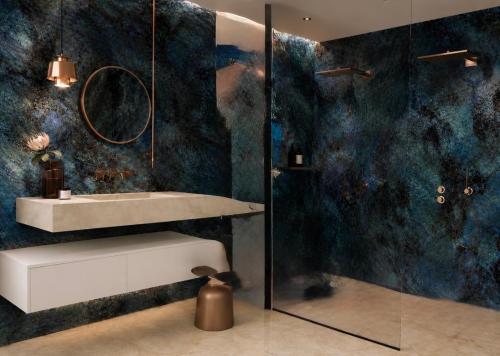 a bathroom with a sink and a shower at Alpine Residence by alpenappartements in Mayrhofen