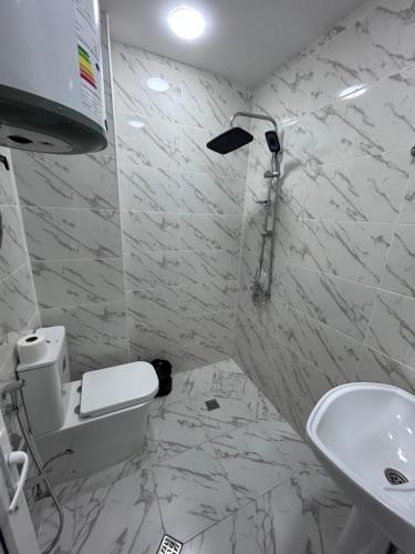 a bathroom with a toilet and a sink at HIQ Hotel Home Inn Qusar in Qusar
