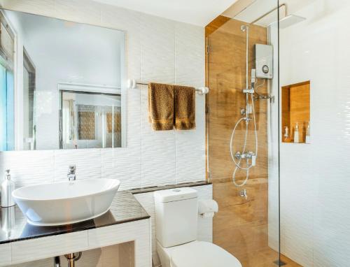 a bathroom with a sink and a toilet and a shower at Family House Zen Boutique Resort in Pai