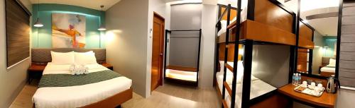 a small bedroom with a bed and a bunk room at ECL Travellers Inn in Nabas