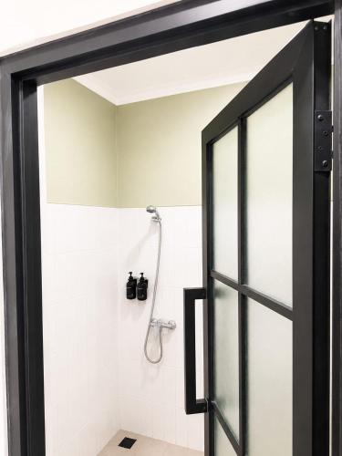 a bathroom with a shower with a glass door at U Residence in Bengkulu