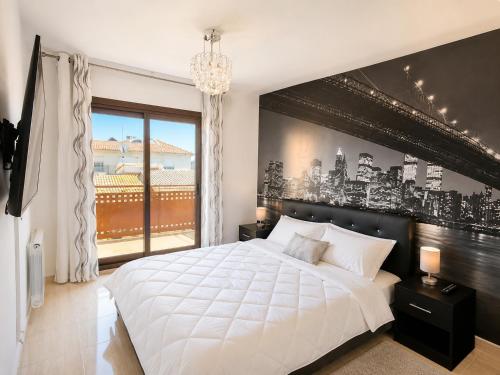 a bedroom with a large white bed and a window at Casa Roda de Bará & Spa in Roda de Bará