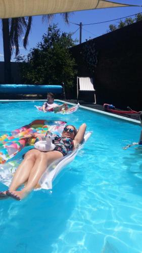 a group of people laying in a swimming pool at Bidgee Motor Inn in Hay