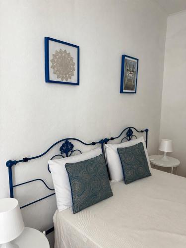 a bedroom with a bed with two pictures on the wall at Akonxego&Cia in Mourão