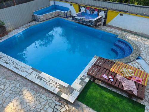 an overhead view of a swimming pool with a table and a bench at Vila Darkoni2 in Bijeljina
