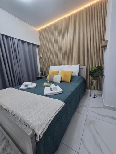 a bedroom with a bed with two towels on it at Marble Coast Studio Apartment in Larnaca