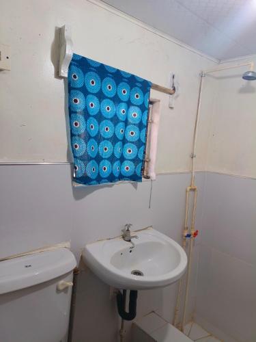 a bathroom with a sink and a blue towel at Tiko Community Centre in Saint Francis