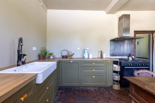 a kitchen with a sink and a stove at Clos de Gauville in Brétigny