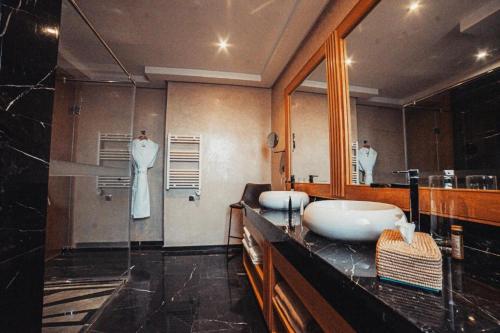 a bathroom with two sinks and a large mirror at SUMAHAN SUITES & SPA in Marrakesh