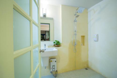 a bathroom with a sink and a shower at Annowa Resort - Chanthaburi in Chanthaburi