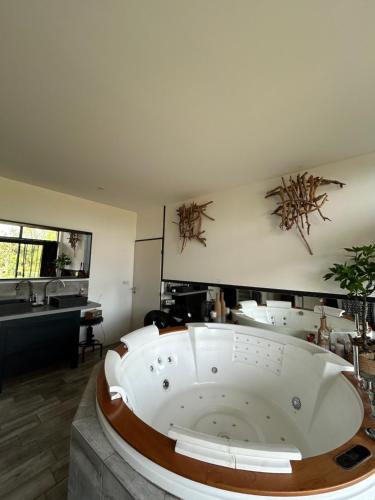 a large white bath tub in a room at Maison en pierre in Saint-Cyr