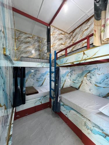 a bunk bed room with two bunk beds in it at Jungle Ippie Hostel in Tanah Rata
