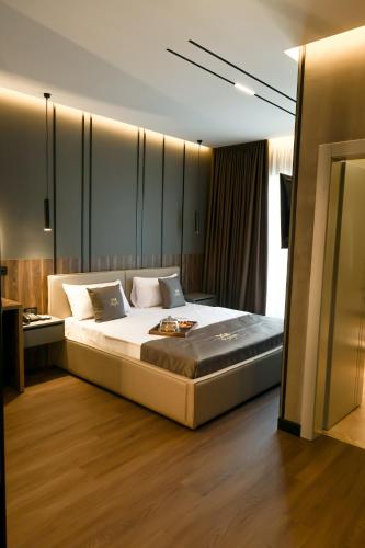 a bedroom with a large bed in a room at Xhasen Hotel & Café in Tirana