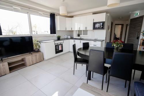 a kitchen and dining room with a table and chairs at Central Penthouse with massive terrace in San Ġwann